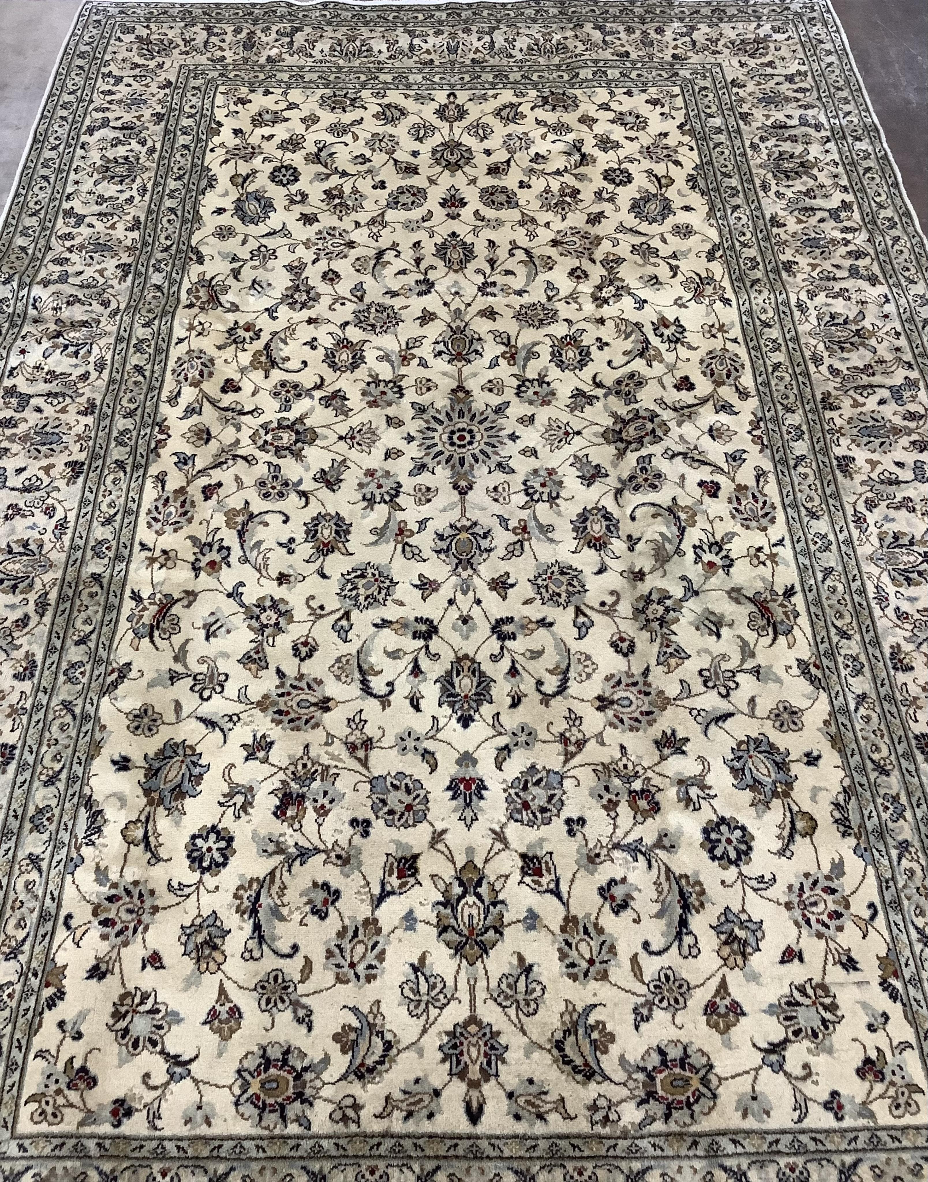An ivory ground Kashan carpet, 305 x 196. Condition - good